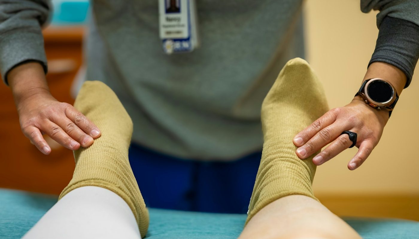 Healthcare professional checking a patient's feet